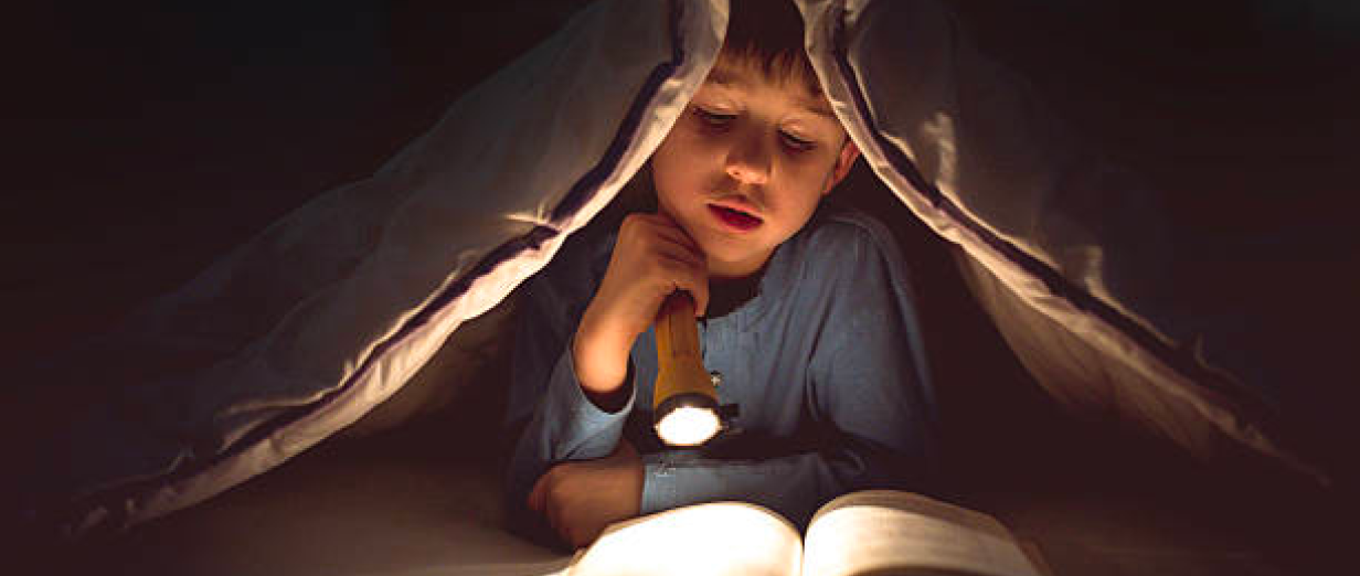 Reading by flashlight.