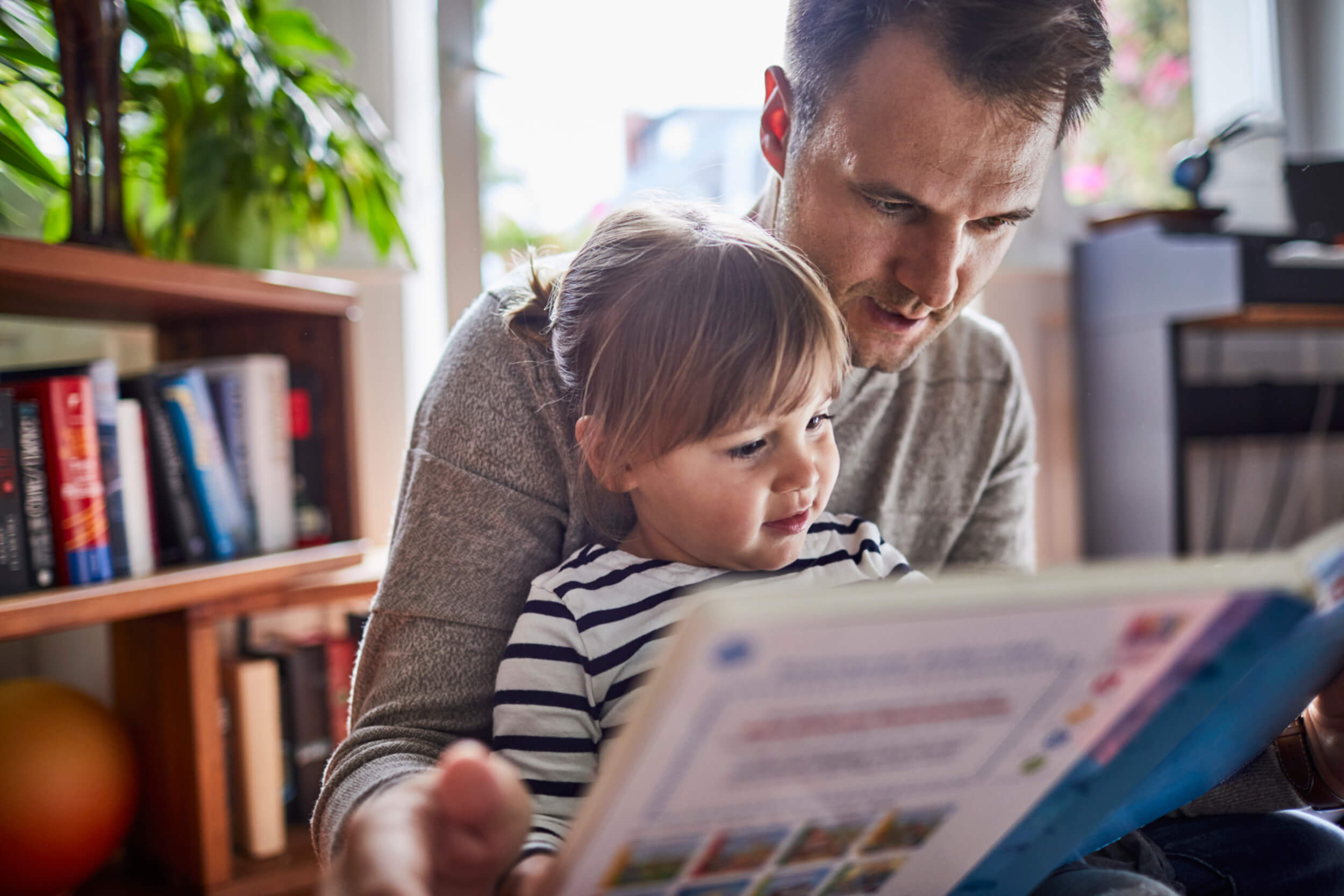 A father and daughter reading